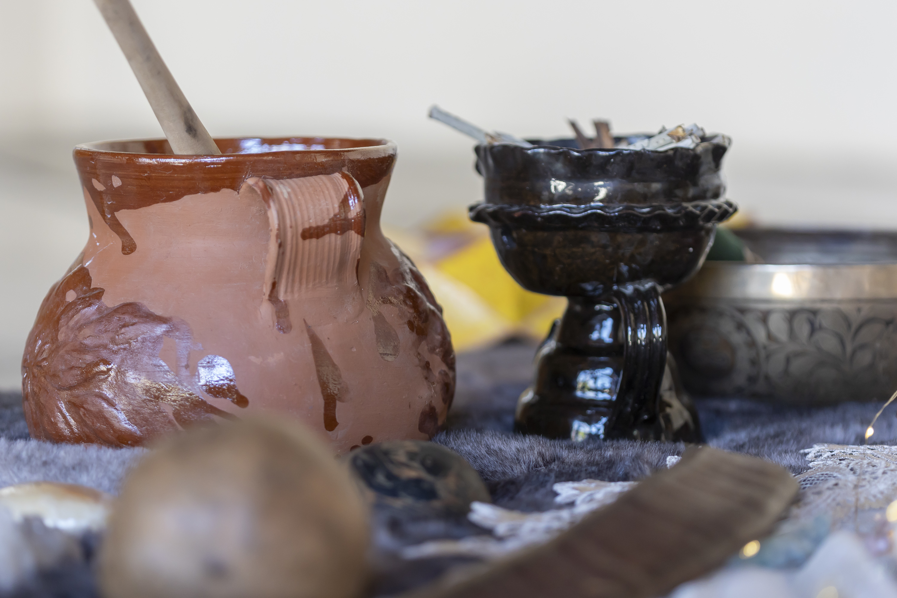 Clay vessel and incense bowl from a Camp Cabo ceremony setup.