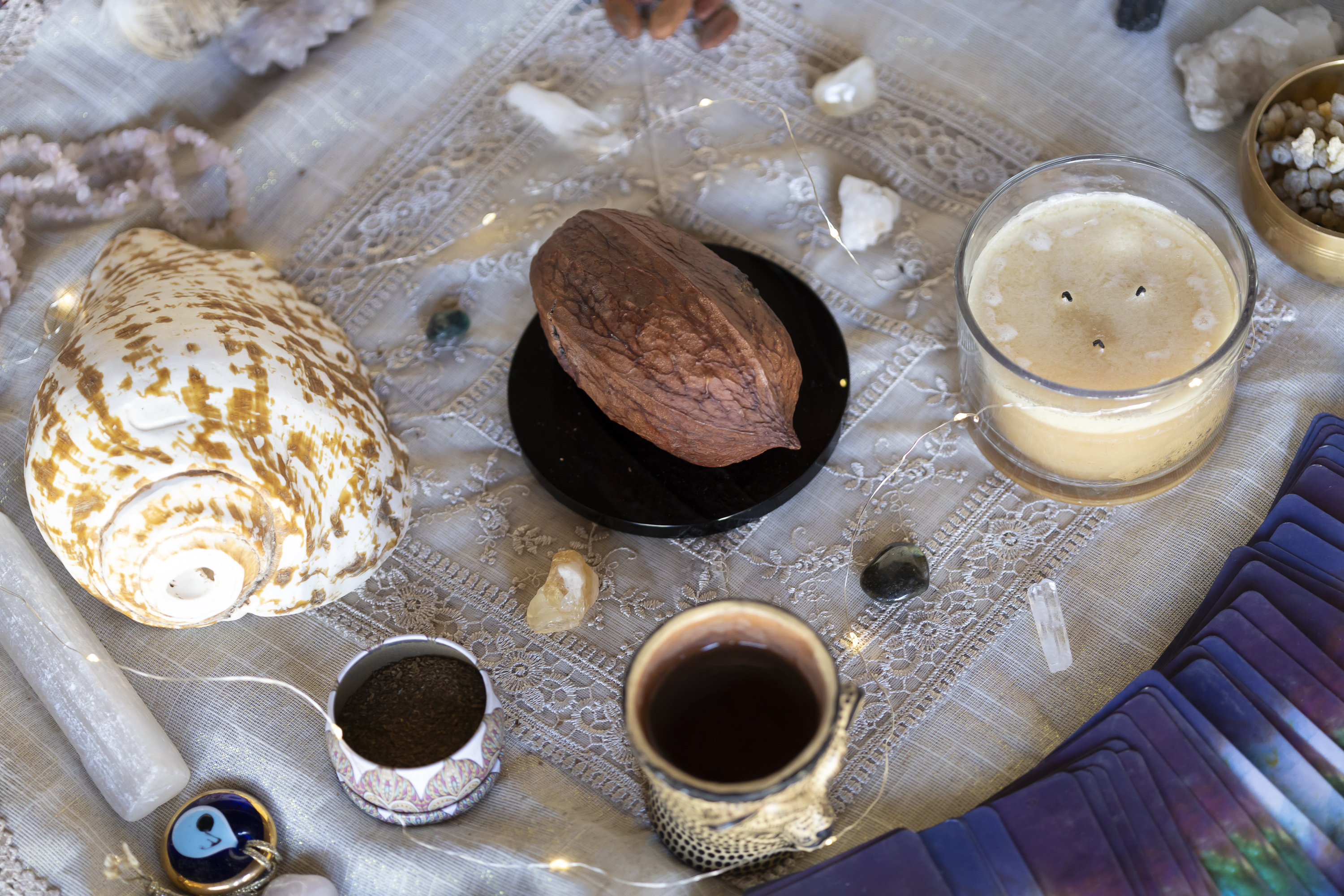 Cacao, shells, crystals, and candles arranged for a full private wellness ritual.