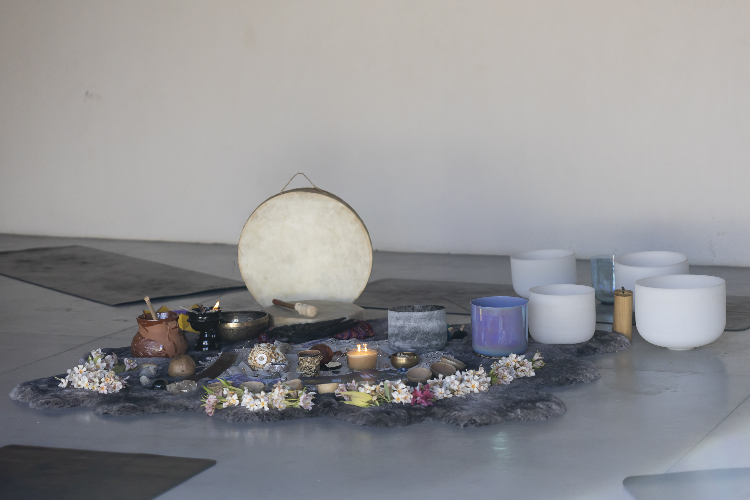 Session setup with bowls, flowers, and instruments arranged inside the Camp Cabo studio.