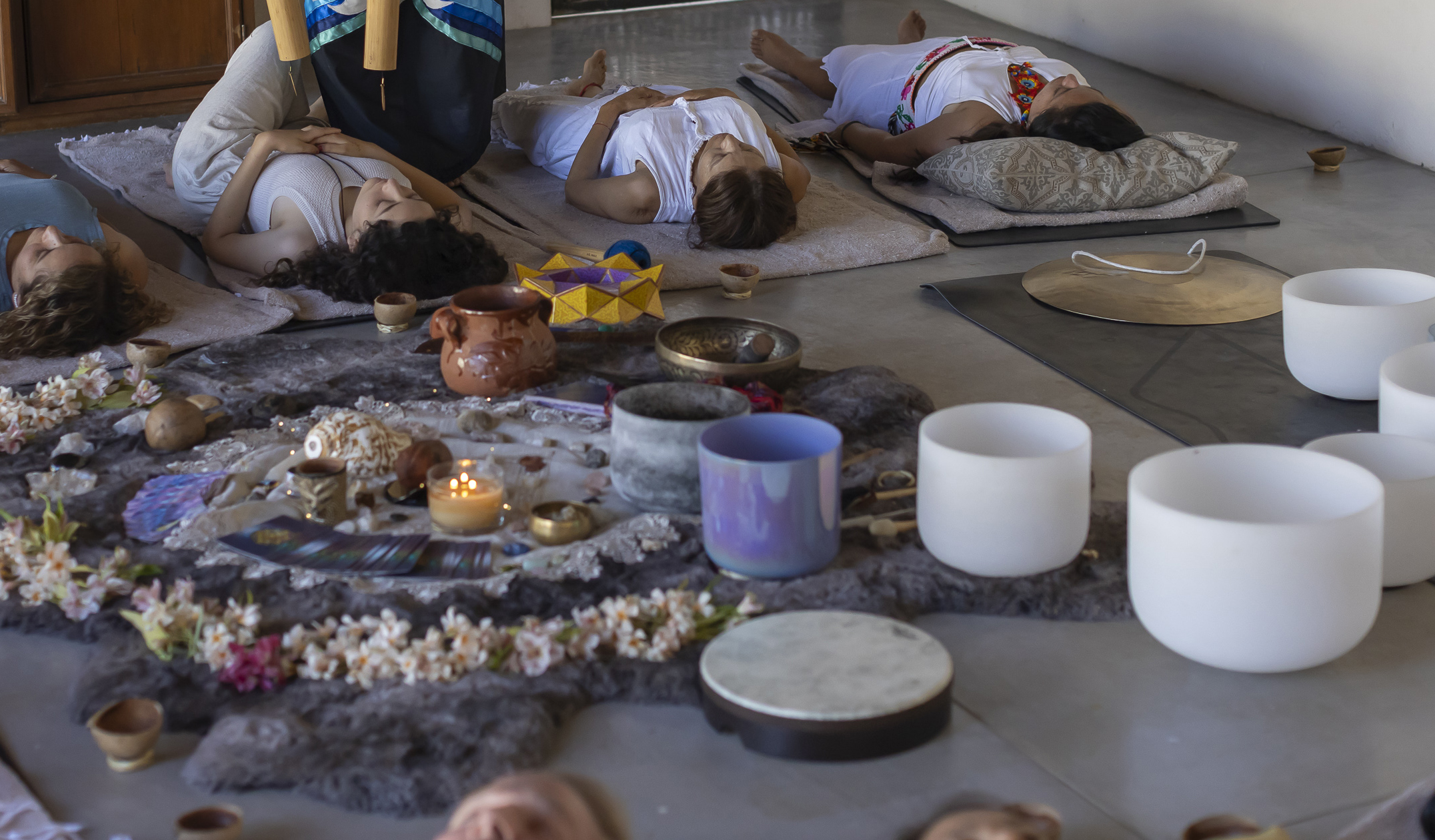 Guests resting during a private sound healing session surrounded by bowls and instruments.